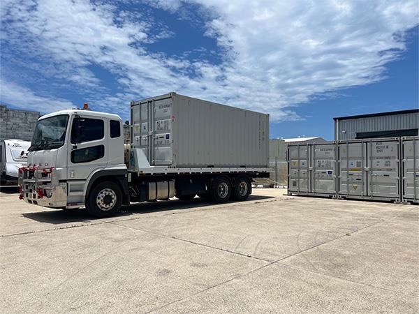 shipping container being deliverd to storage yard